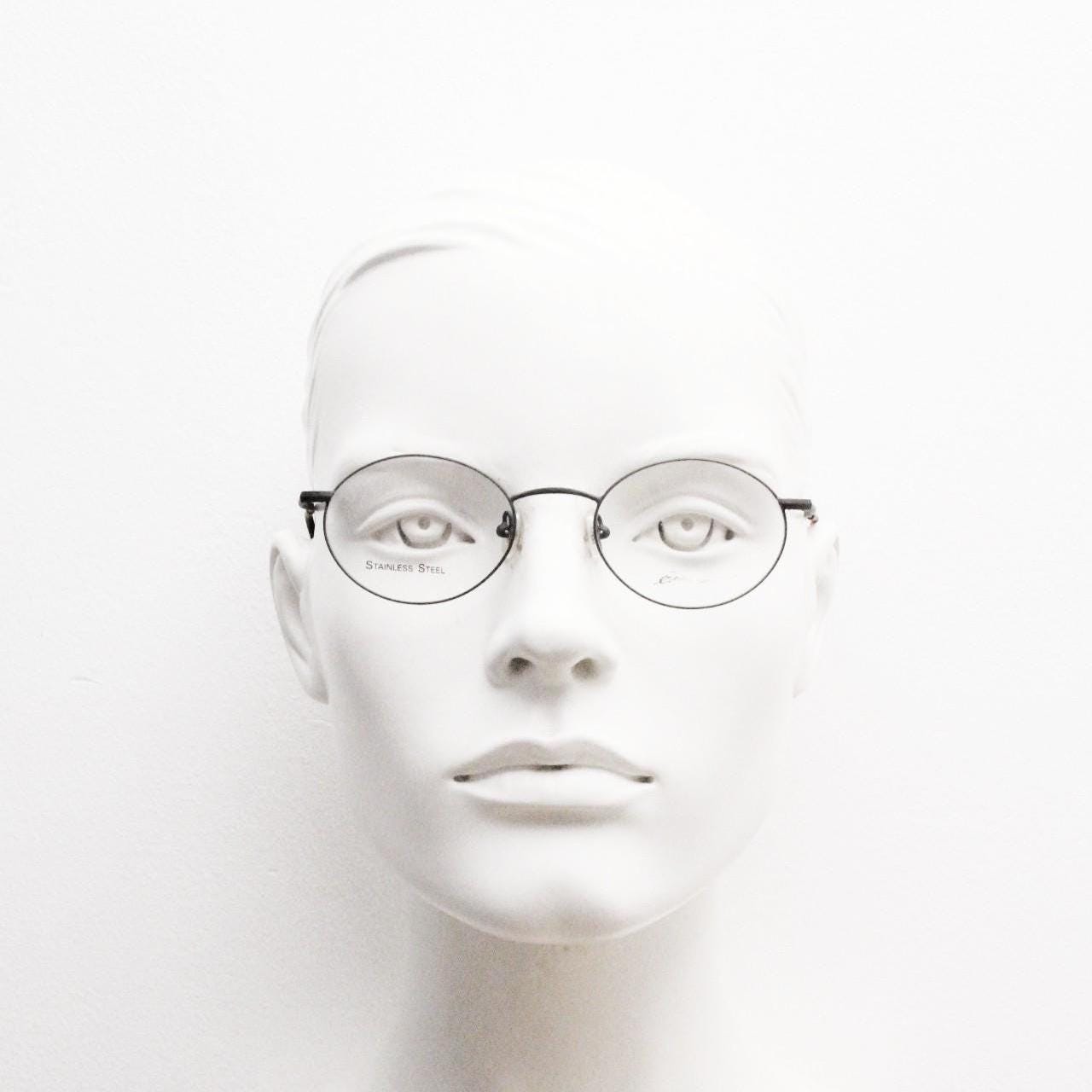 Eddie Bauer 90s vintage oval eye glasses. Minimal black matt finish optical frames with kinked arms. Stainless steel spectacles. NOS