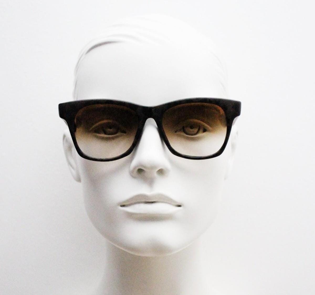 Vintage 80s square horn rim sunglasses. All time classic design in chunky matt black and brown frame with superb graduating lenses. NOS