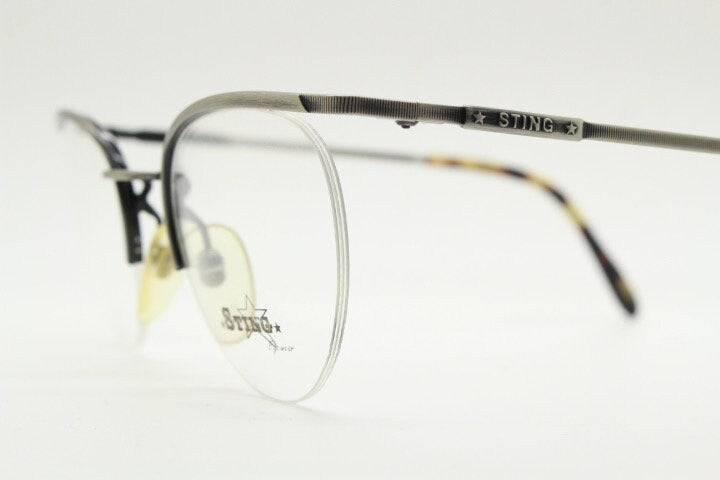 Sting 90s vintage round eye glasses. Minimal pewter finish metal half frame brow line optical frames. Prescription eyeglasses. RX. NOS