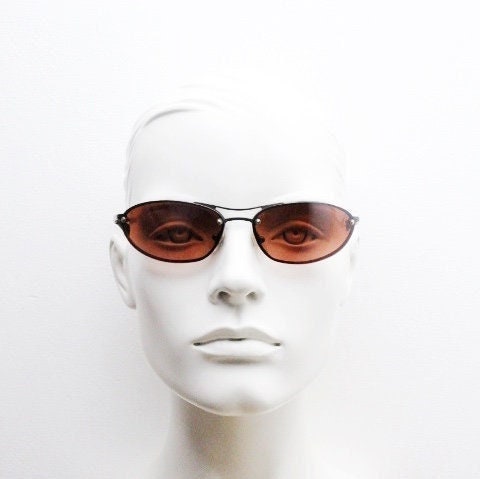 Y2K vintage oval sunglasses. Satin finish grey metal frame with amber curved almond bug eye lenses and straight arms. 2000's. NOS