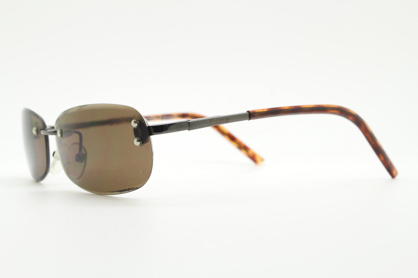 90s vintage minimal frameless sunglasses. Minimal brown rectangular lens with bevelled edges, gunmetal grey trim and tortoise arms. NOS