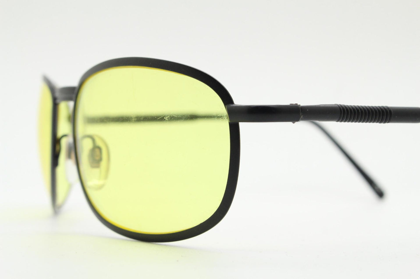 90s vintage oval bug eye sunglasses. Matt black metal frame with blazing yellow lenses and ingenious temple springs. 2000s. NOS