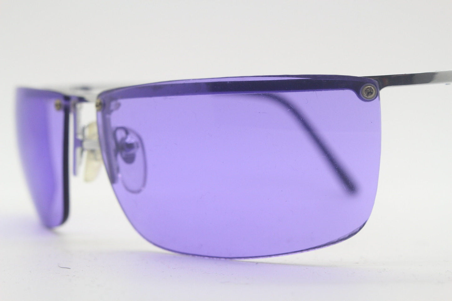 Y2K vintage purple shield sunglasses. 2000's half frame wraparound aerodynamic mini mask visor with curving lenses. 90s 00s unused NOS