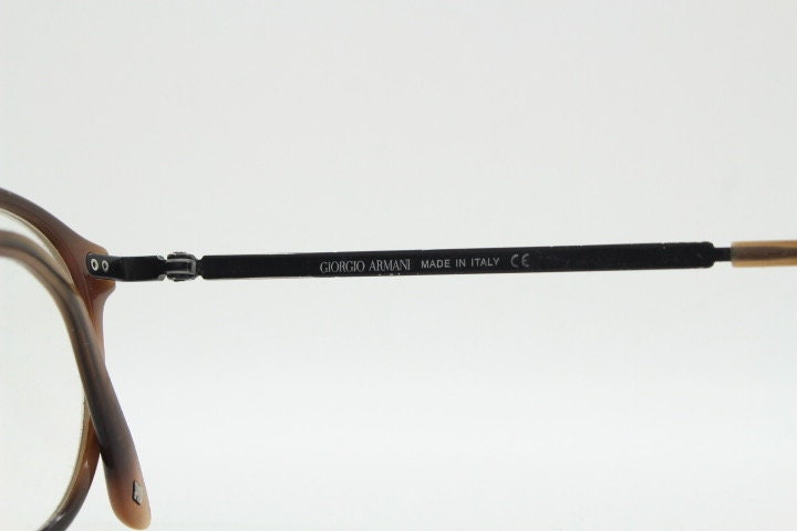 Giorgio Armani eye glasses model 7124 made in Italy. Mottled brown acetate optical frames with flat metal arms. Prescription eyeglasses. RX