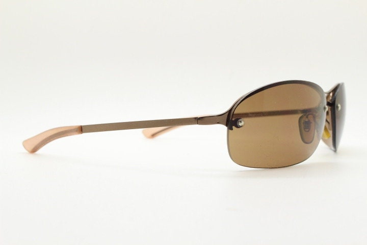 Y2K vintage oval aviator sunglasses. Metallic brown chrome half frame with mid tone curved bug eye lenses and straight arms. 2000's. NOS