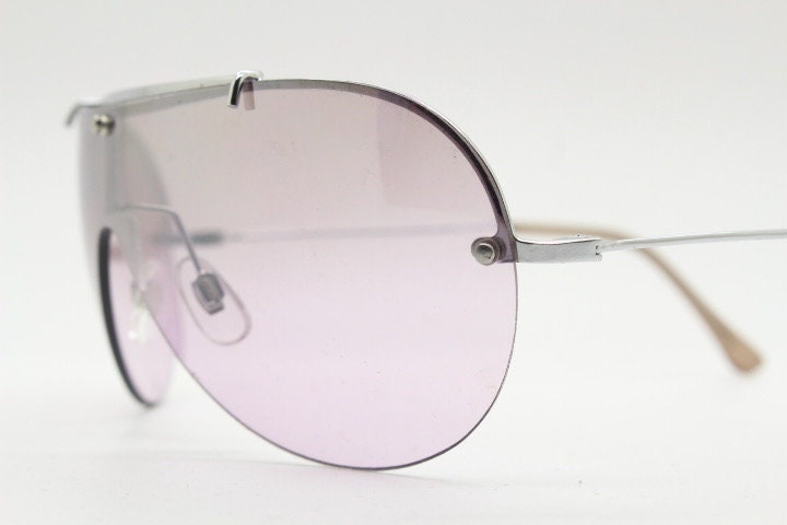 Y2K vintage visor shield sunglasses. Silver chrome half frame with pink wraparound mono lens and mirror glaze. Mini mask. 00's. 2000's NOS