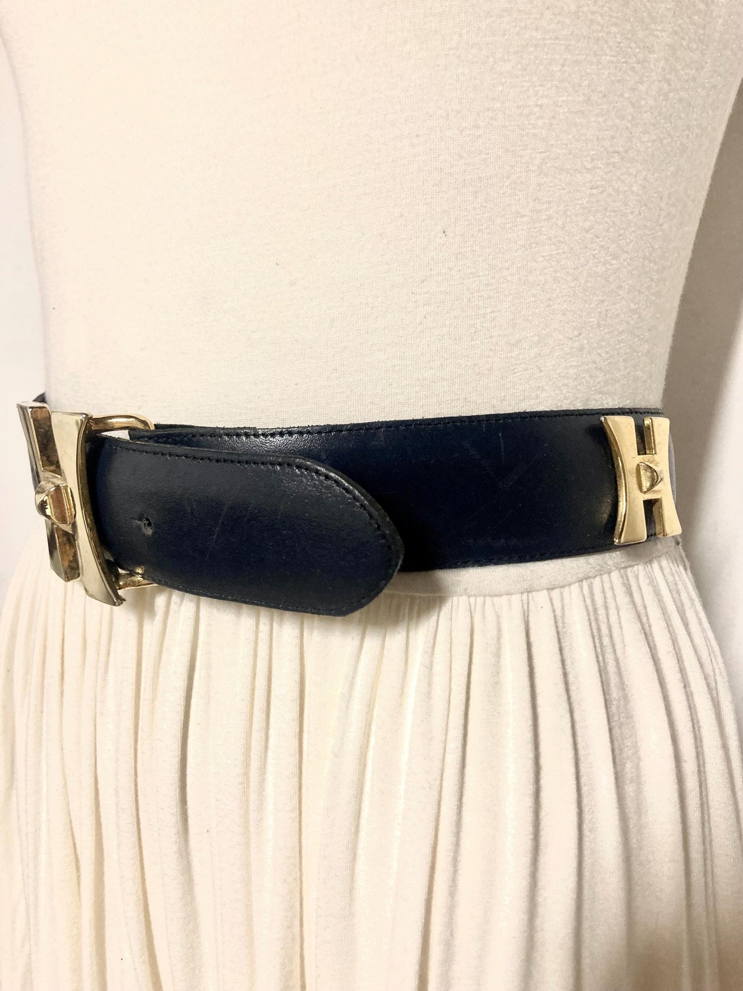 80s vintage womens dress belt in navy blue genuine leather with substantial gold chrome studded 'H' motifs. Made in France. Size S
