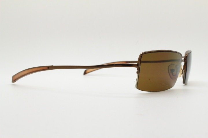 Y2K vintage curved rectangular sunglasses. Minimal half frame in brown chrome with mid tone lenses and straight arms. 2000's. 00's NOS
