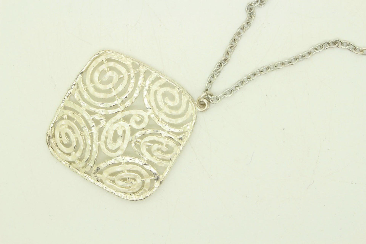 60s vintage large silver square pendant necklace made in England. Satin and matt finish with swirling paisley cut out shapes. Womens. NOS