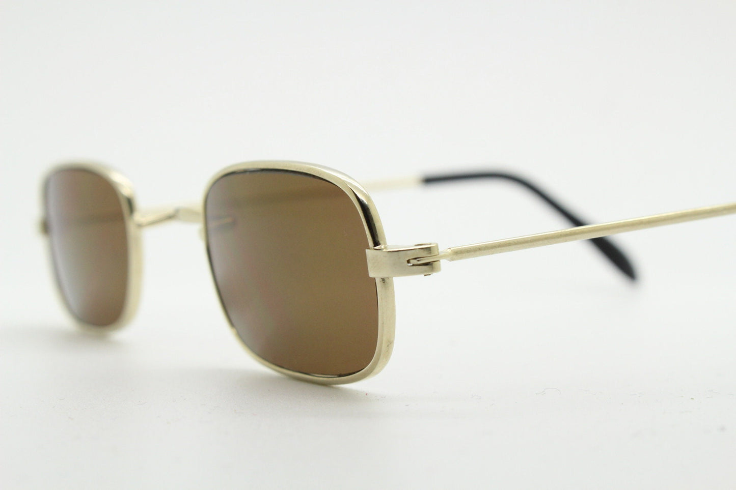 80s vintage rectangular low profile metal sunglasses. Minimal 60s mens mod design in gold chrome frame with brown lenses. NOS