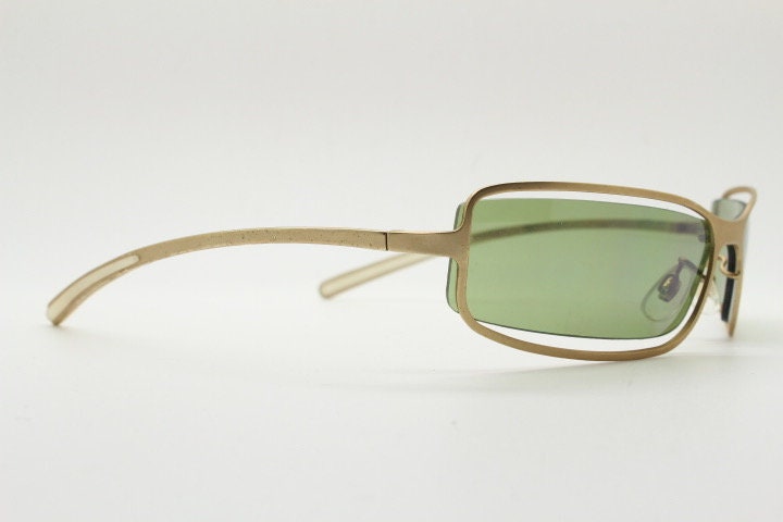 Y2K vintage wraparound sunglasses. Low profile satin finish golden slender frame with green lenses and gap feature. 2000's. 90s. NOS