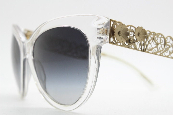 Dolce and Gabbana oversized cateye sunglasses model 4211. Womens transparent cat eye with cut-out florid metal arms and smoky lenses. NOS