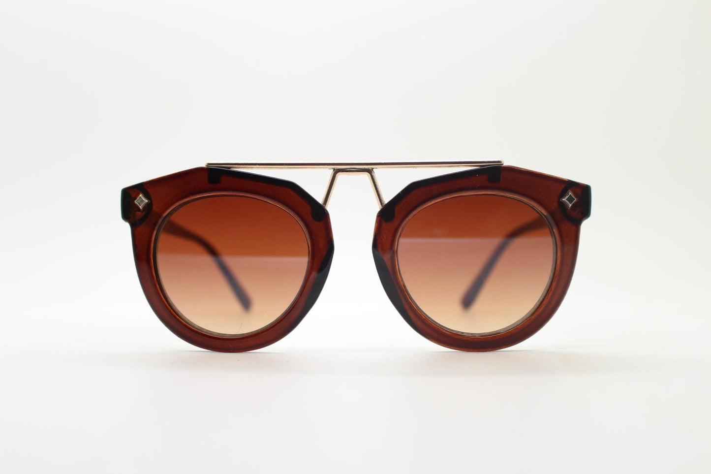 Rounded cateye sunglasses with gold 'scaffold' metal bridge. Women's transparent frame with matching brown graduating lenses. Vintage NOS