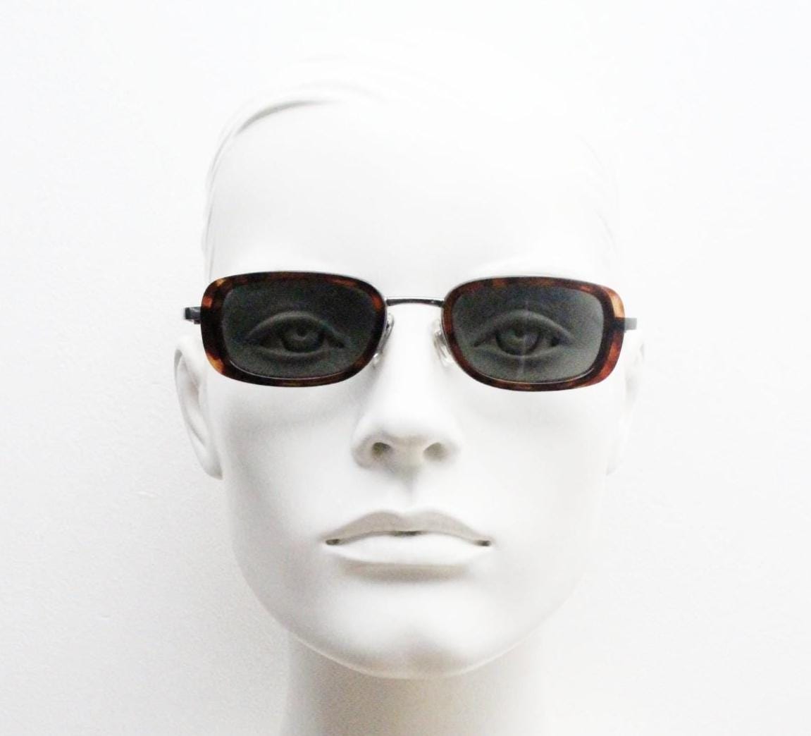 90s vintage rectangular sunglasses. Grey chrome metal frame with protruding tortoise insets, matching ear bends and green lenses