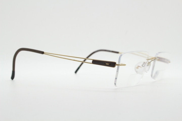 Silhouette rectangular frameless eye glasses model 7677 made in Austria. Minimal lightweight optical frame with golden trim. Prescription RX