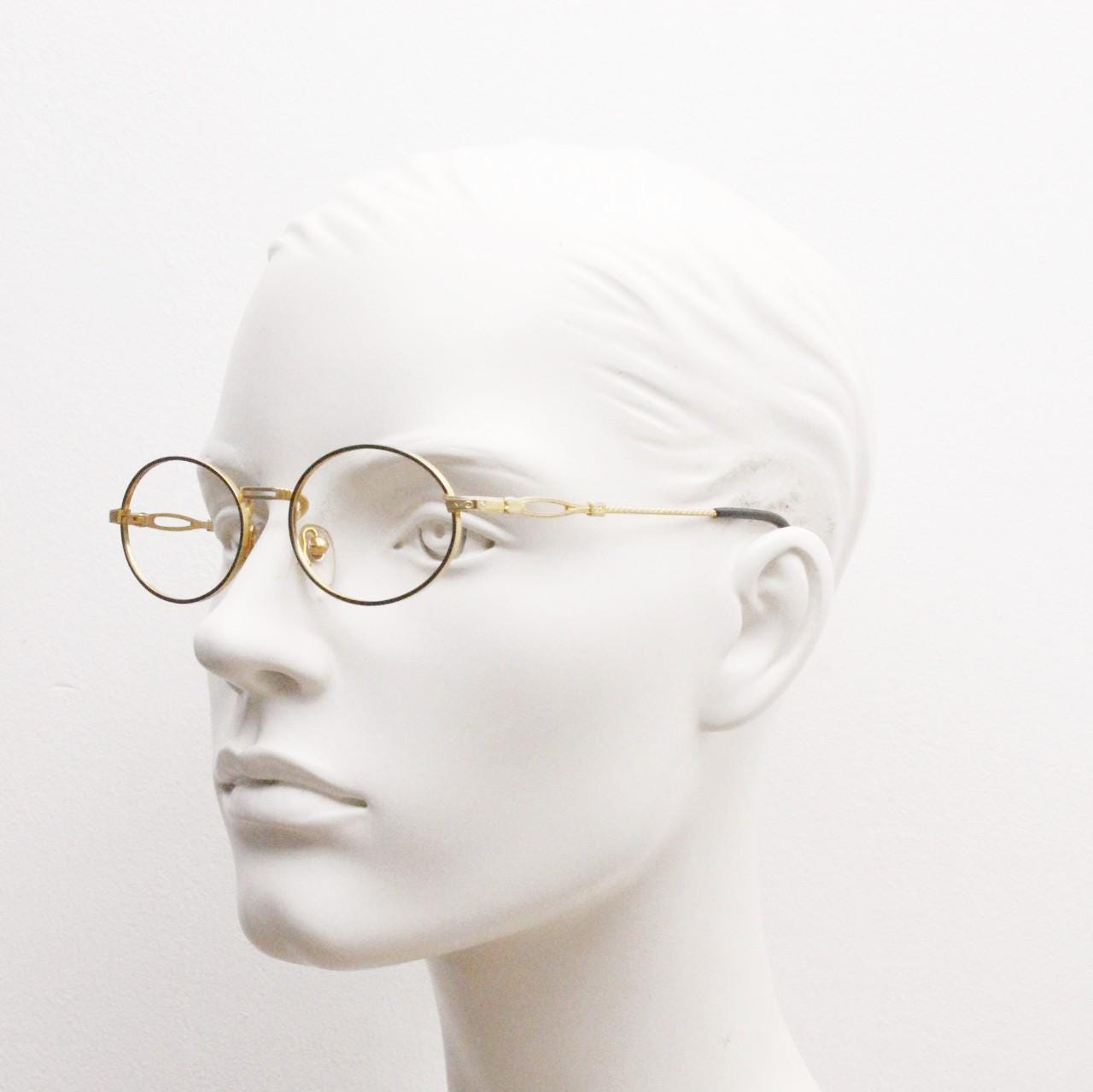 90s vintage small oval eye glasses. Gold and black optical frames with ornate arm details. Prescription RX steampunk spectacles. NOS