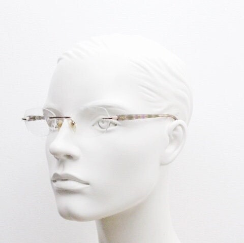 Vogue vintage frameless oval eye glasses. Transparent acetate arms with purple and green tones. Minimal Prescription RX Optical frame