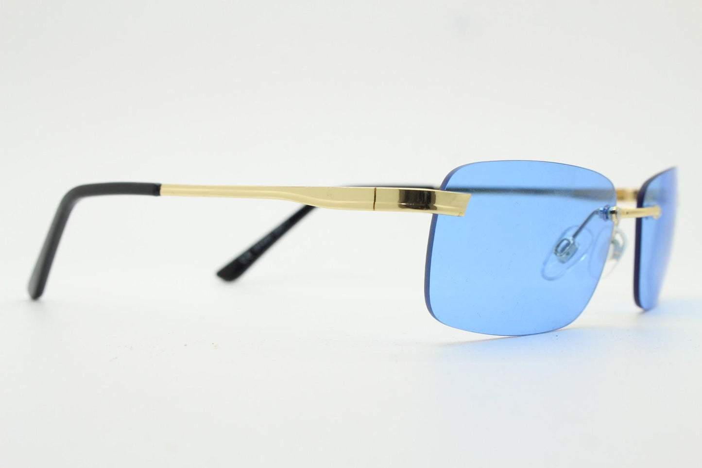 Y2K vintage frameless sky blue sunglasses. Minimalistic rectangular lenses with gold bridge and arms. 2000s club kids. 00's. 90s Rave