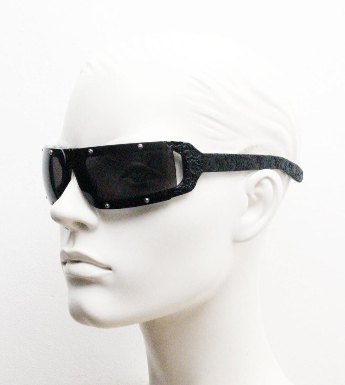 Buddhist Punk wrap around sunglasses hand made by Linda Farrow. Black acetate frame with abstract cut out patterns. Projects. Vintage. NOS