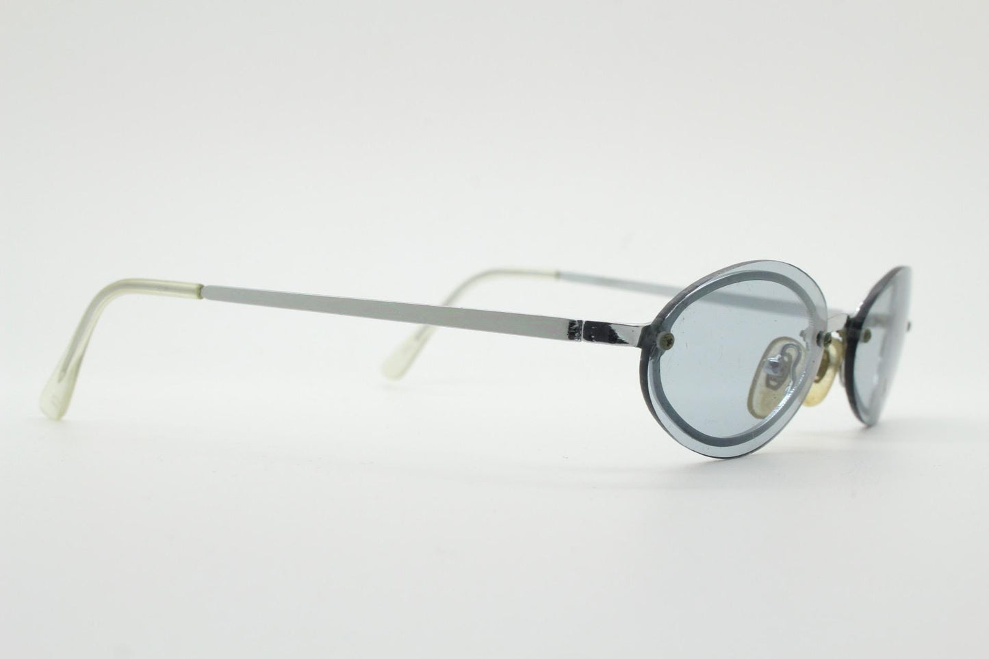 90s vintage small oval sunglasses. Minimal silver chrome metal frame with overlapping light tone grey lenses. Micro. Steampunk