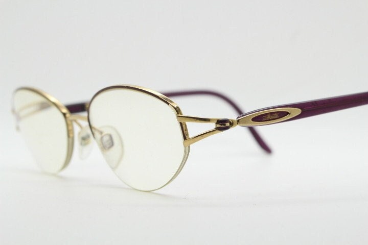Silhouette oval half frame eye glasses model 6566 made in Austria. Minimal optical frame with gold trim deep purple arms. Prescription RX