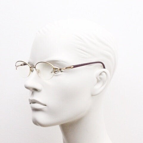 Silhouette oval half frame eye glasses model 6566 made in Austria. Minimal optical frame with gold trim deep purple arms. Prescription RX