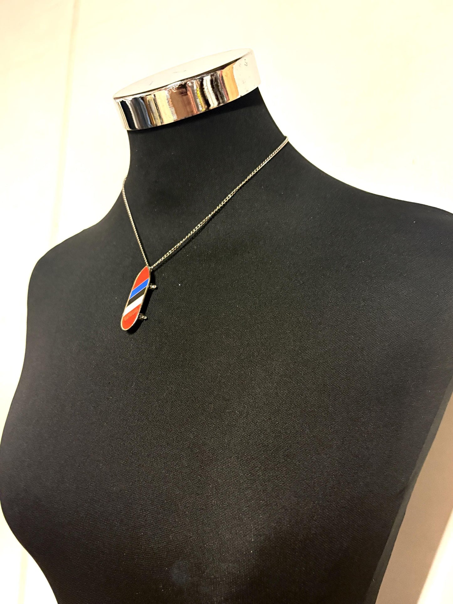80s vintage skateboard pendant necklace. Metal chrome with enamelled red, blue and white colour stripes. Charming authentic design. NOS