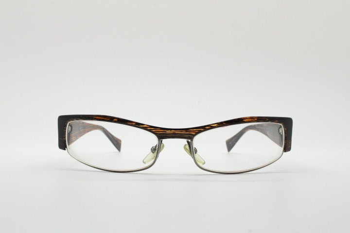Alain Mikli 90s vintage eye glasses hand made in France. Low profile wrap around half frame in 'wood grain' acetate. Optical prescription RX