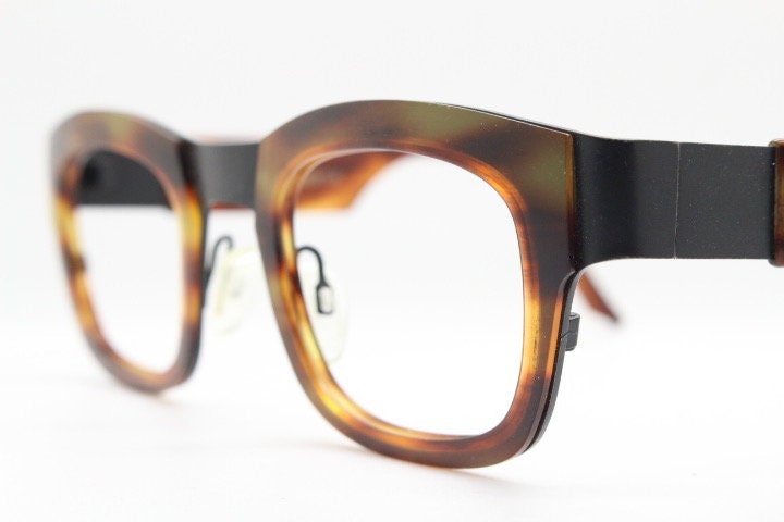 Anne et Valentin rectangular eye glasses hand made in France. Black matt titanium optical frame with mottled brown acetate. Prescription RX