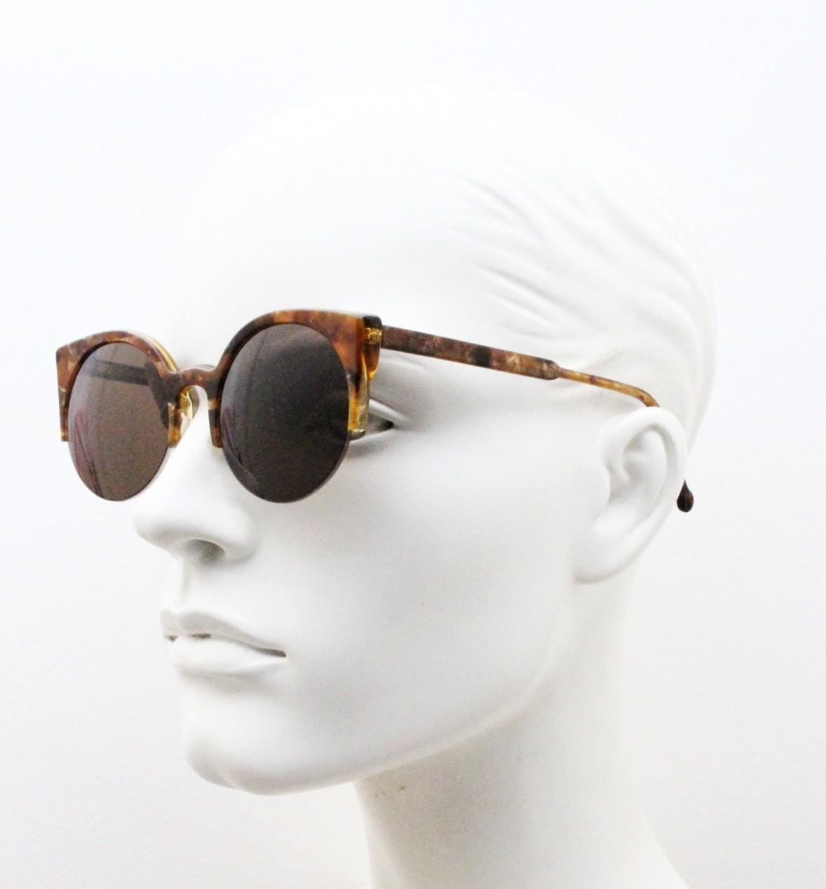 Retrosuperfuture vintage angular cat eye sunglasses made in Italy. Marbled brown gloss acetate flat top half frame with round lenses