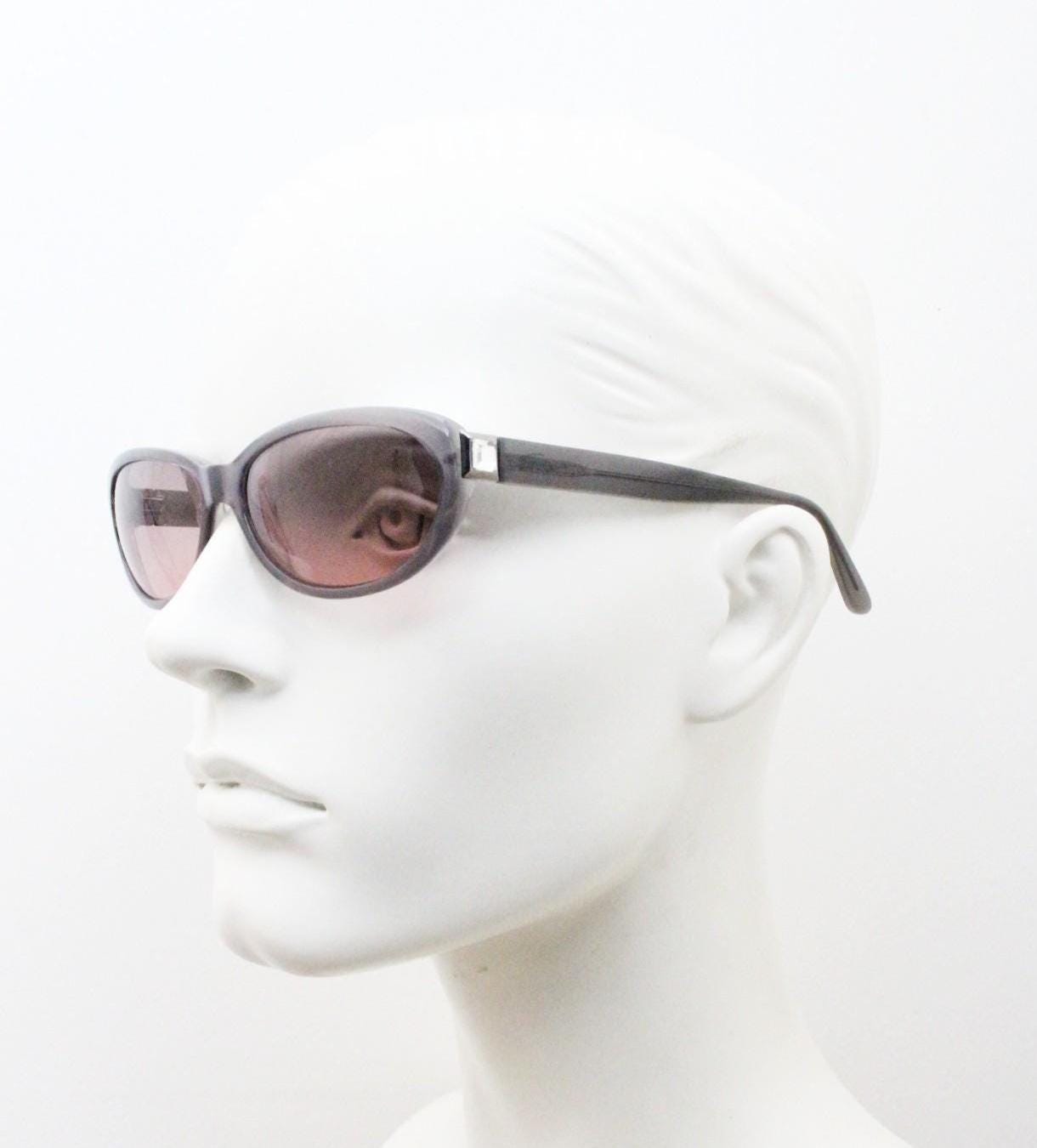 Genny 90s vintage oval cat eye sunglasses made in Italy. Transparent dark grey acetate frame with pink lenses. Womens NOS cateye. BNWT