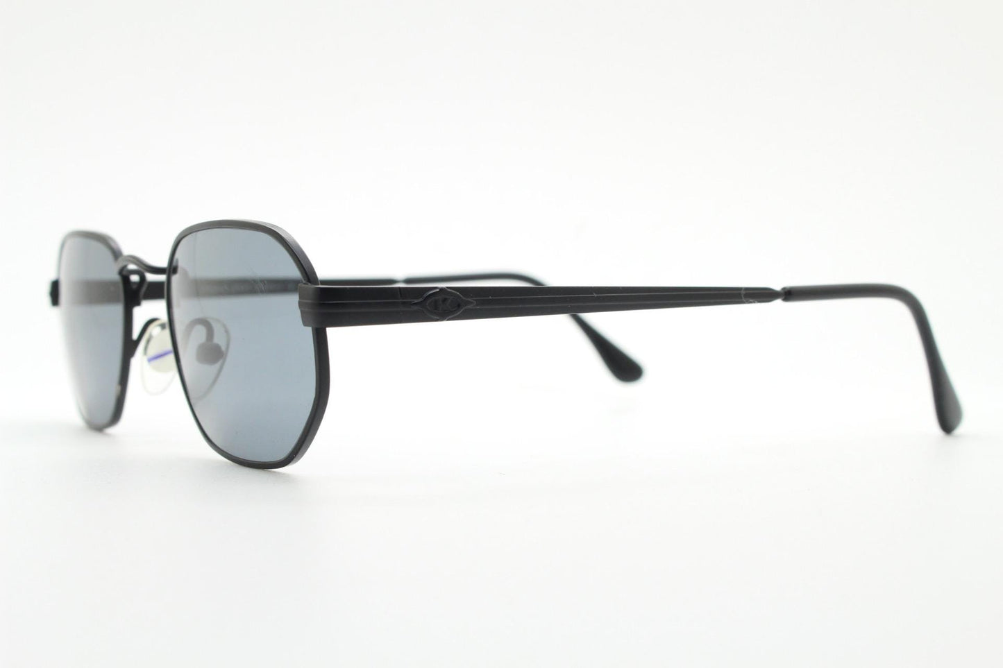 Prestige 90s vintage small oval sunglasses model 119 made in Italy. Black matt metal frame with with subtle angular facets, NOS octagon