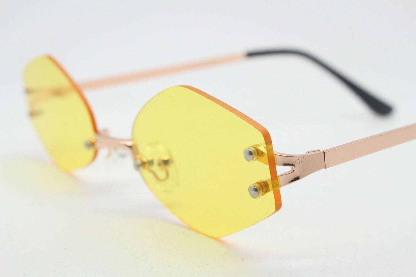 Y2K vintage frameless hexagon sunglasses. Bright yellow lenses with rose gold bridge and arms. 2000s, 00's. 90s