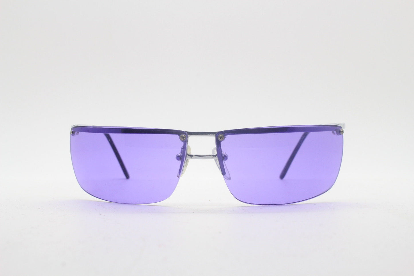Y2K vintage purple shield sunglasses. 2000's half frame wraparound aerodynamic mini mask visor with curving lenses. 90s 00s unused NOS