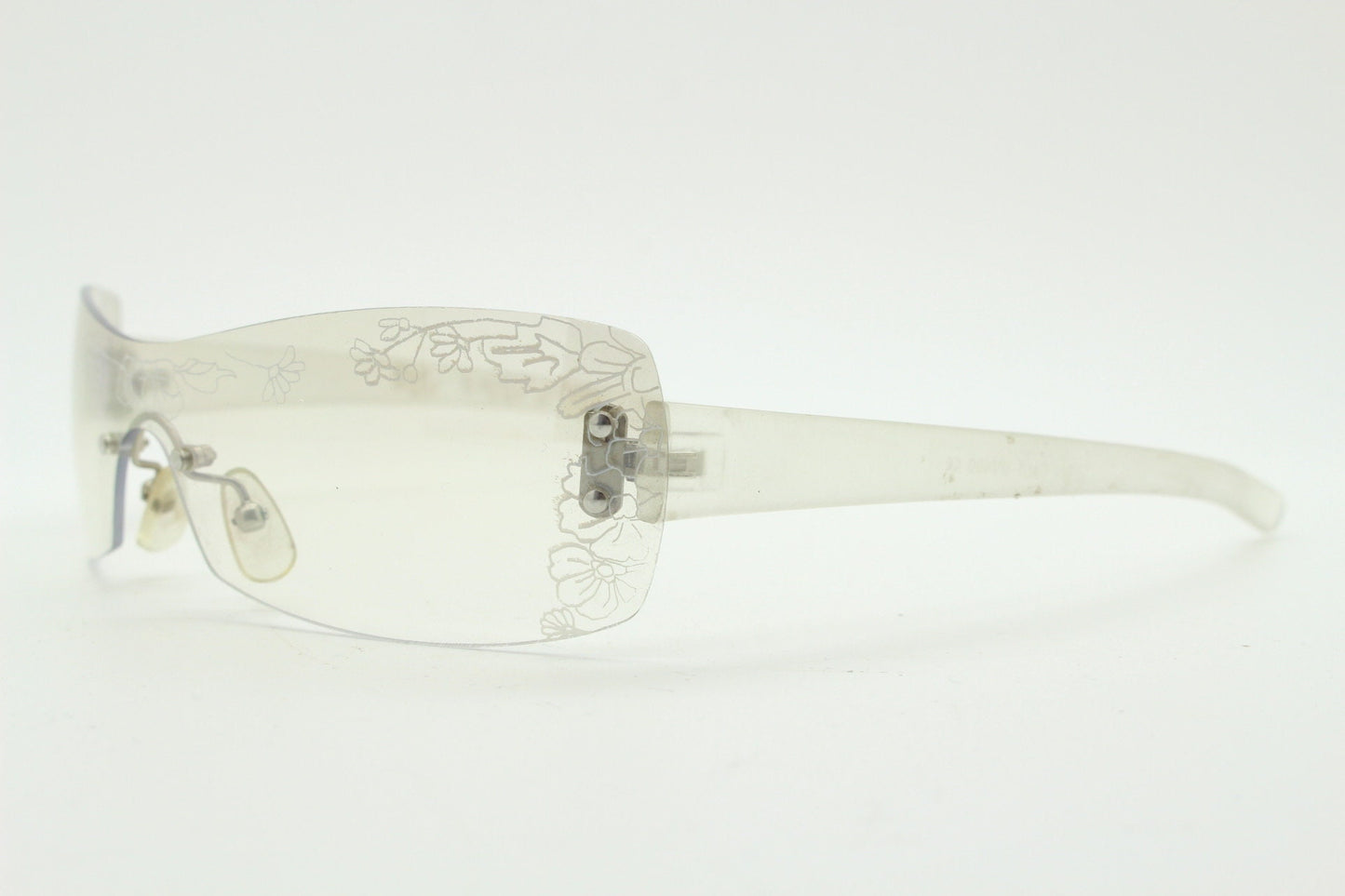 Y2K vintage visor sunglasses. Frameless 2000's wraparound mini mask shield design with light tone mirror mono lens and flower print. 00s NOS
