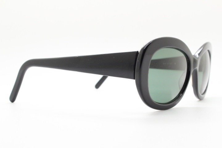 Calvin Klein vintage oval cateye sunglasses made in Italy. Womens plain black gloss thickened acetate cat eye. Classical 60s design. Y2K