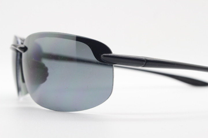 Maui Jim sport wrap around sunglasses made in Japan. Lightweight half frame shield with curving lenses. 2000's. Y2K