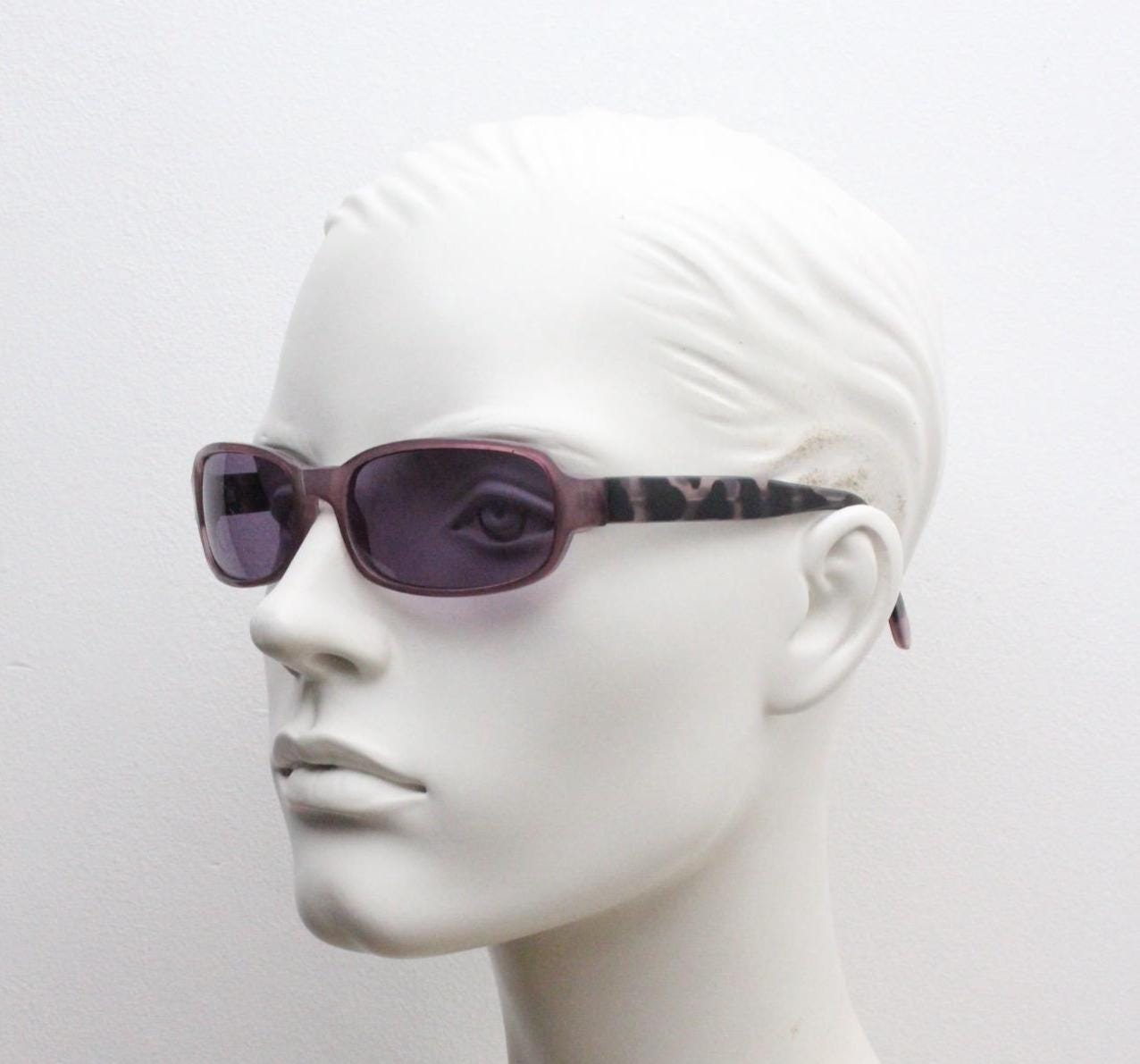 Y2k vintage wrap around sunglasses. Curved low profile frame with extraordinary purple turtle arms and well matched lenses. 2000's NOS