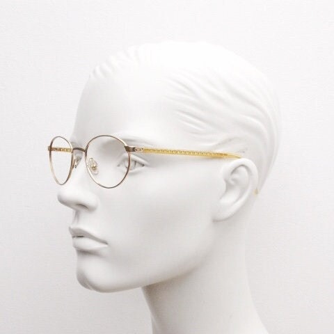 Christian Dior 90s vintage oval eye glasses made in Austria. Lustrous gold finish optical frame with CD chain link arms. Prescription RX NOS