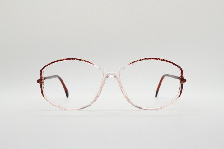 Silhouette 80s vintage hexagon eye glasses made in Austria. Transparent crystal optical frame with abstract red pattern. Prescription RX