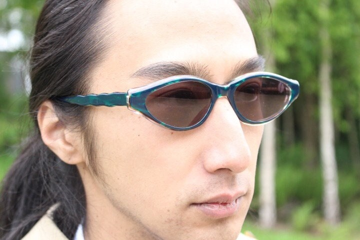 Francois Pinton Paris 90s vintage cat eye sunglasses made in France. Exaggerated  cateye in green and brown acetate with waved arms. NOS