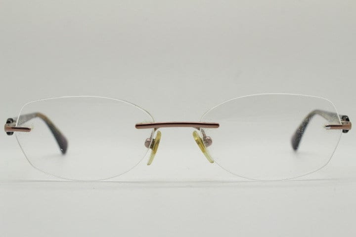 Vogue vintage frameless oval eye glasses. Transparent acetate arms with purple and green tones. Minimal Prescription RX Optical frame