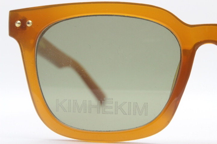 KIMHEKIM oversized wayfarer design sunglasses model J00\2. Transparent amber acetate chunky frame with 2 logo green lenses. BNWOT