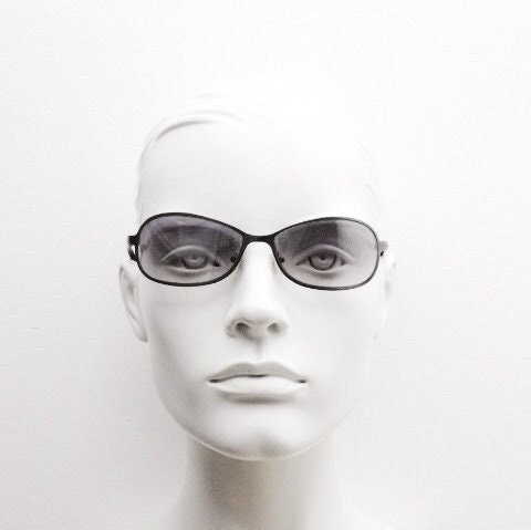 Y2K vintage mini bug eye sunglasses. Curved gunmetal grey flat metal frame with black matt arms and graduating lenses. Unused 2000s NOS