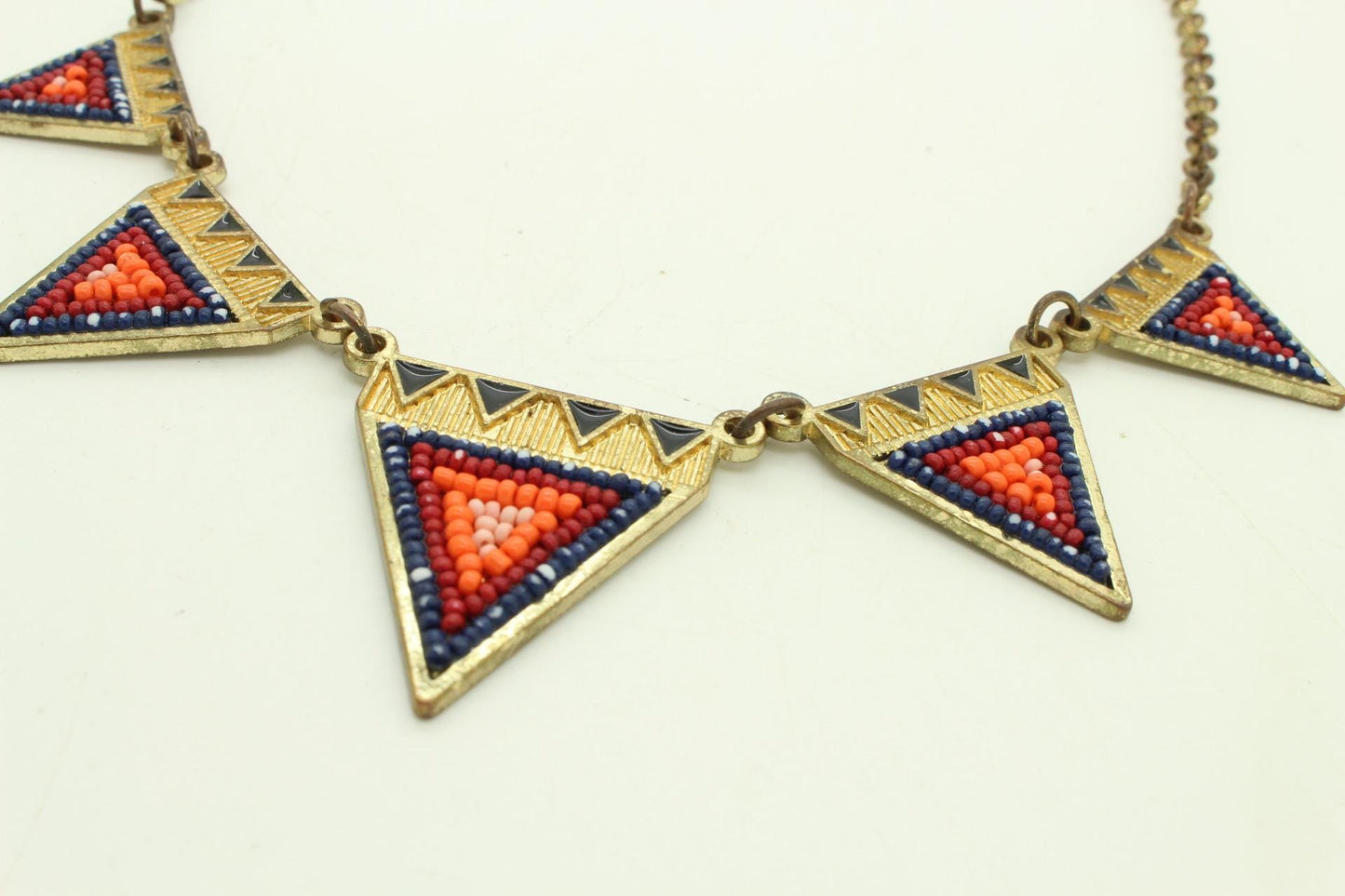 80s vintage gold triangles necklace. Aztec style with multi coloured bead inlays and ornate patterns. Womens statement design