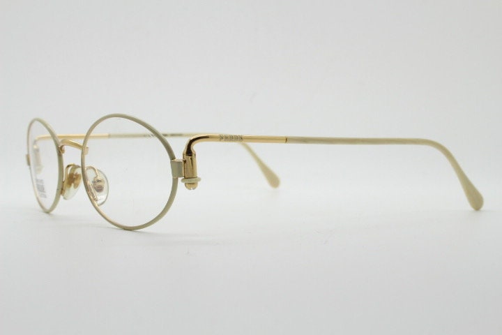 Gianfranco Ferre 90s vintage oval eye glasses made in Italy. White and gold metal tech design optical frame. Prescription RX spectacles. NOS