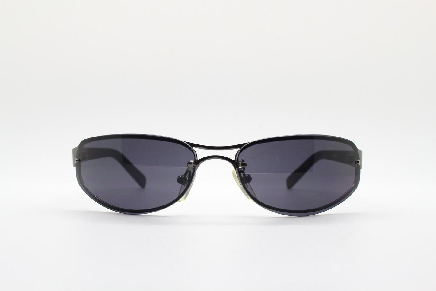 Y2K vintage small bug eye oval sunglasses. Gunmetal grey chrome metal frame with curved bug eye lenses and matt black arms. 2000's NOS