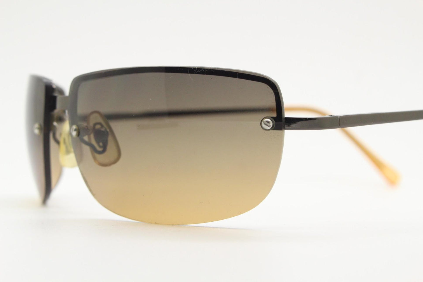 Y2K vintage curved rectangular sunglasses. Minimal half frame in brown chrome with grey to amber fade lenses. 2000's. 00's NOS