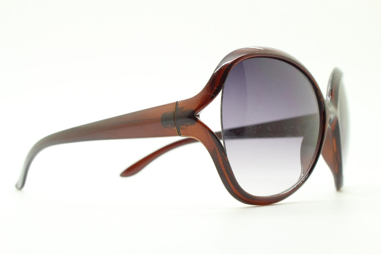 Y2K vintage big round angular sunglasses. Women's 70s design in transparent brown with graduating lenses and forked side detail. 2000s NOS