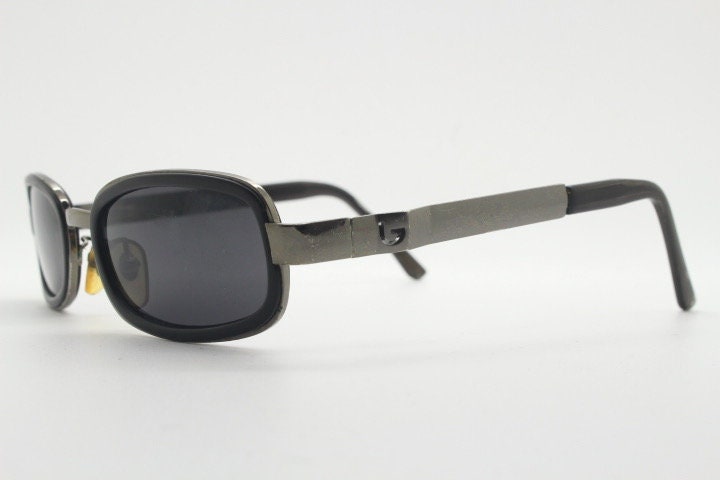 Byblos 90s vintage low profile rectangular sunglasses made in Italy. Gunmetal grey chrome frame with black insets and cut out arm logo's